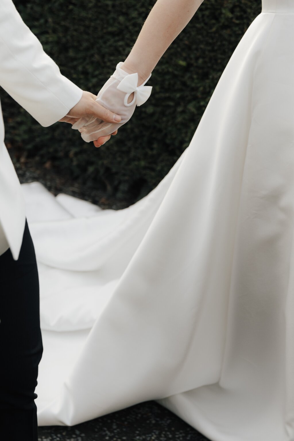 bridal details. holding hands with elegant gloves.