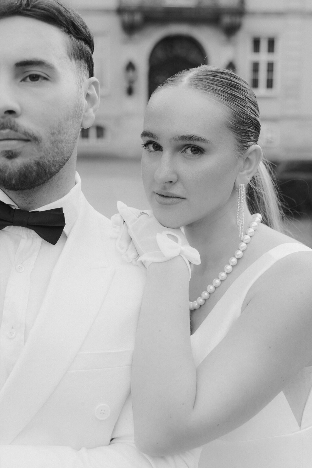 elegant bride is posing with her groom.