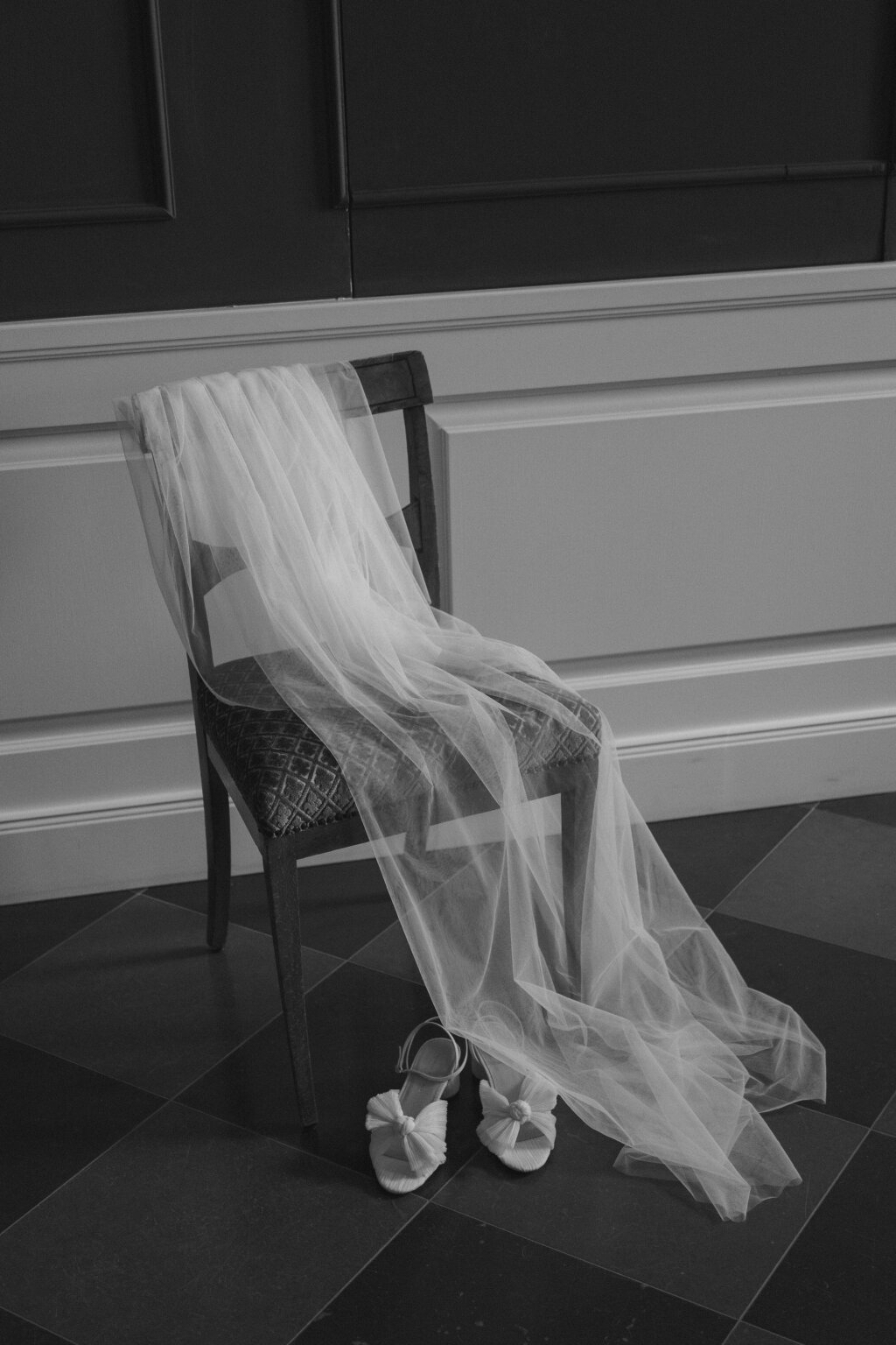 the veil and the bridal shoes on an old chair.
