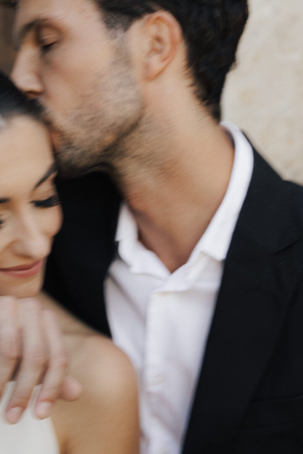 groom is kissing his bride.