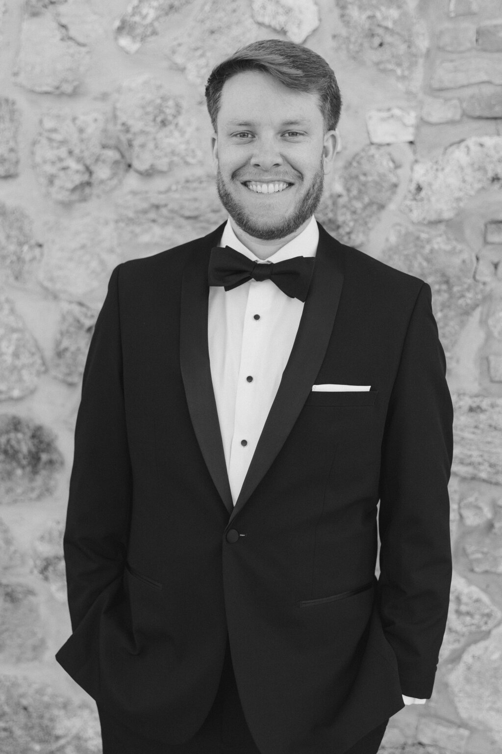 smiling groom in his black smoking on his wedding day.